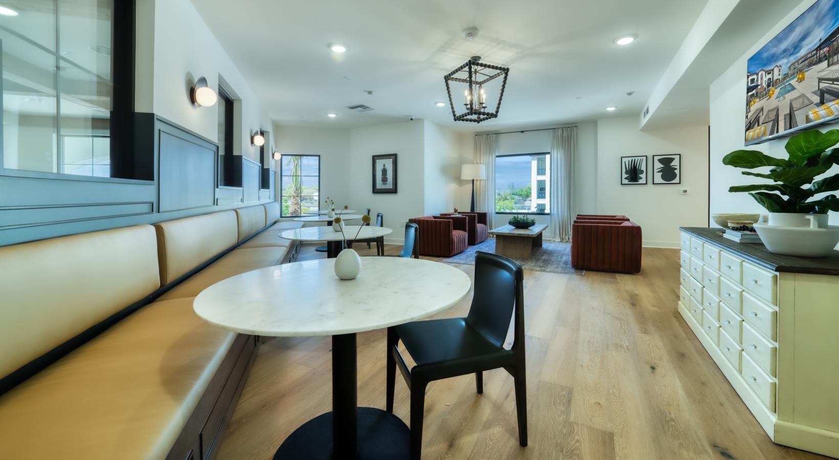 Enjoy our resident-only features a room with a table chairs and a window