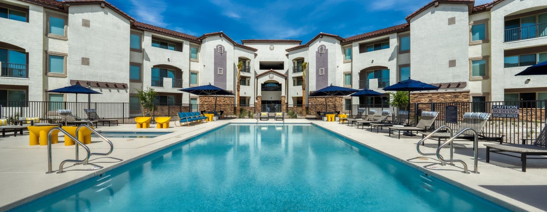 a pool in a courtyard with buildings around it