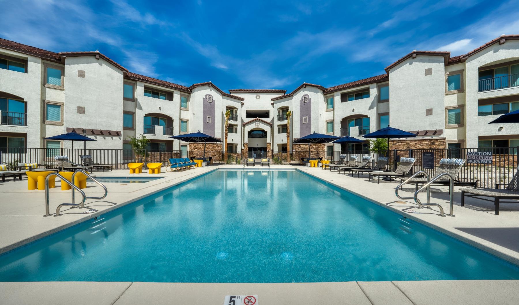 a pool in a courtyard with buildings around it