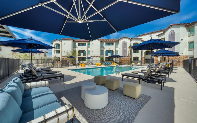 a pool with lounge chairs and umbrellas