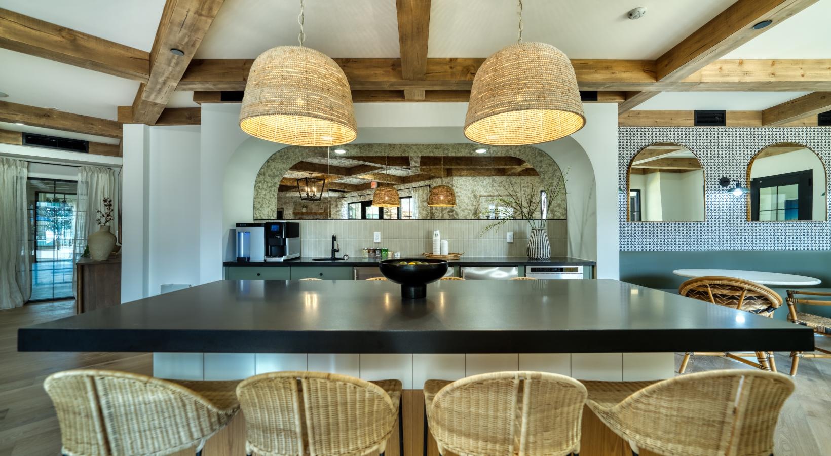 Bustling community with plenty of dining choices a kitchen with a bar and chairs