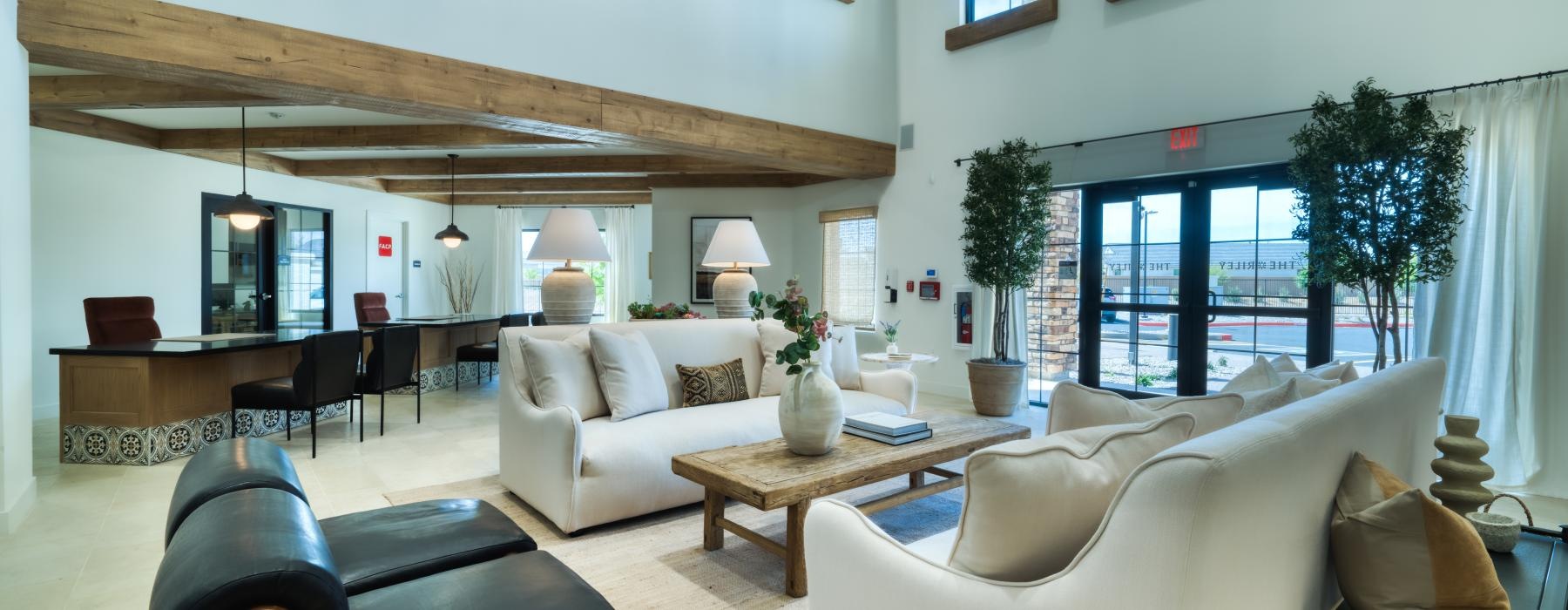 a living room with a piano and couches